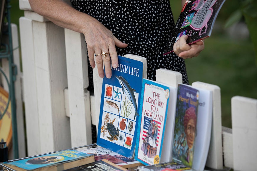 Straight sets out books along the fence.