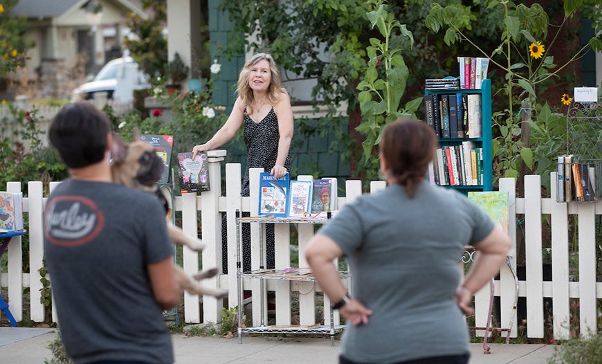 Susan Straight chats with visitors of the fence library.