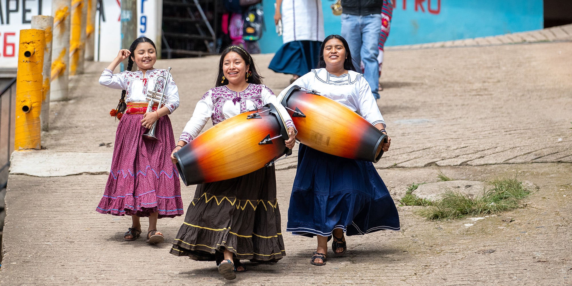 Band members walk into the town of Tlahui to perform.