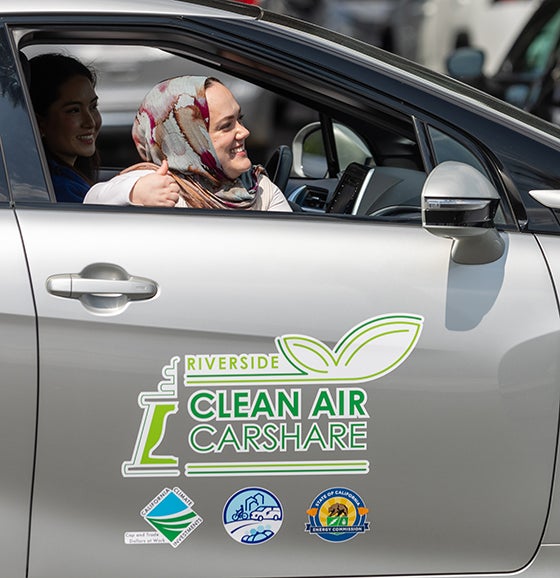 Nour Katabi, a project manager for non-profit CALSTART, gives a thumbs up. (UCR/Stan Lim) while sitting in a hydrogen-engine car during the UCR and the City of Riverside ribbon cutting event of a carshare program on April 28, 2025, at CE-CERT. 
