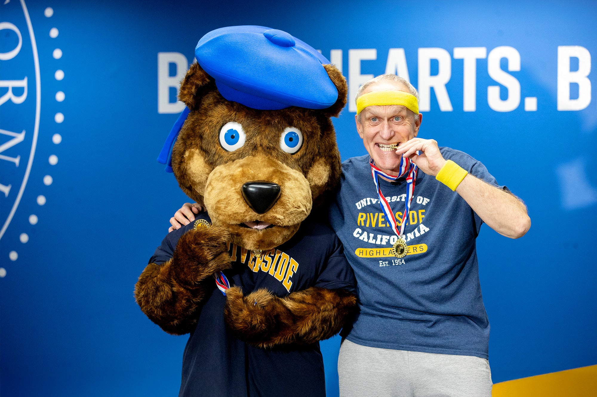 Wilcox poses with Scotty while filming an Olympics-themed welcome video for fall 2024.