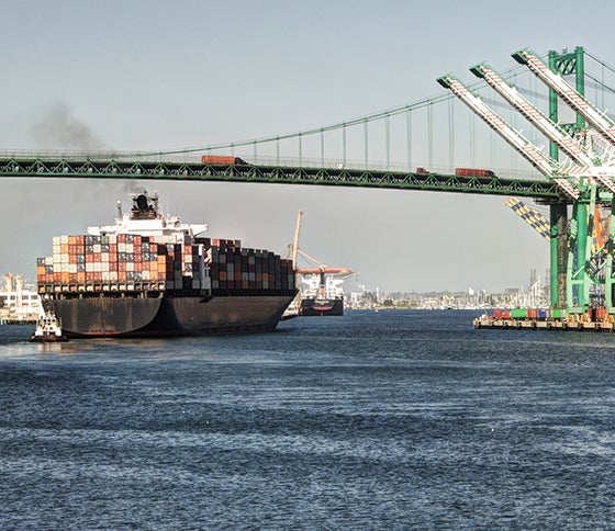 Huge container ship under the historic Vincent Thomas Bridge in San Pedro at Port of Los Angeles. (Getty Images)