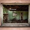 Interior view through a window of a room and fireplace in the Case residence.
