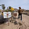 UCR Researcher David Biggs walks past a “No Trespassing” sign down a path leading to the former Case residence.