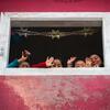Residents wave to the camera from a home in Tlahui.