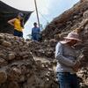 Sugiyama looks into an excavation site in Teotihuacan.