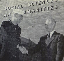 Student-veteran shaking hands with university administrator
