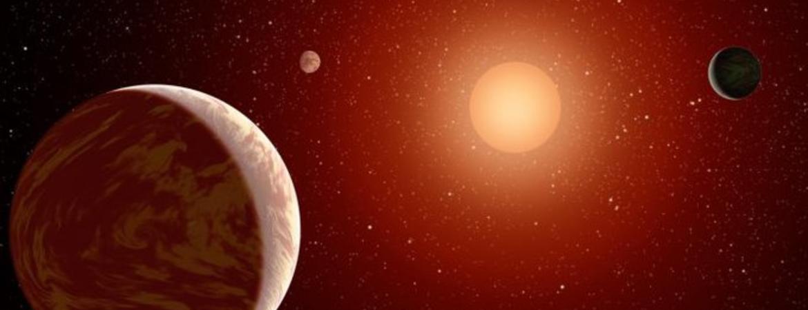 Artist rendering of a red dwarf or M star, with three exoplanets orbiting. About 75 percent of all stars in the sky are the cooler, smaller red dwarfs. IMAGE CREDIT: NASA.