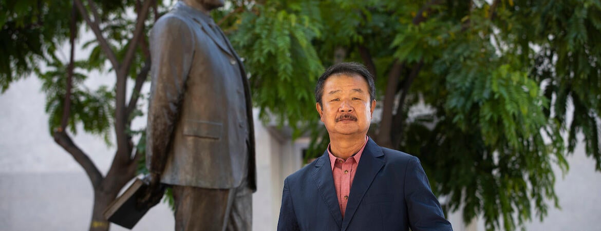 Edward T. Chang, professor of ethnic studies and founding director of the Young Oak Kim Center for Korean American Studies at UC Riverside. He stands in front of the statue of Korean independence activists, Dosan Ahn Chang Ho in downtown Riverside on May 26, 2021. (UCR/Stan Lim)