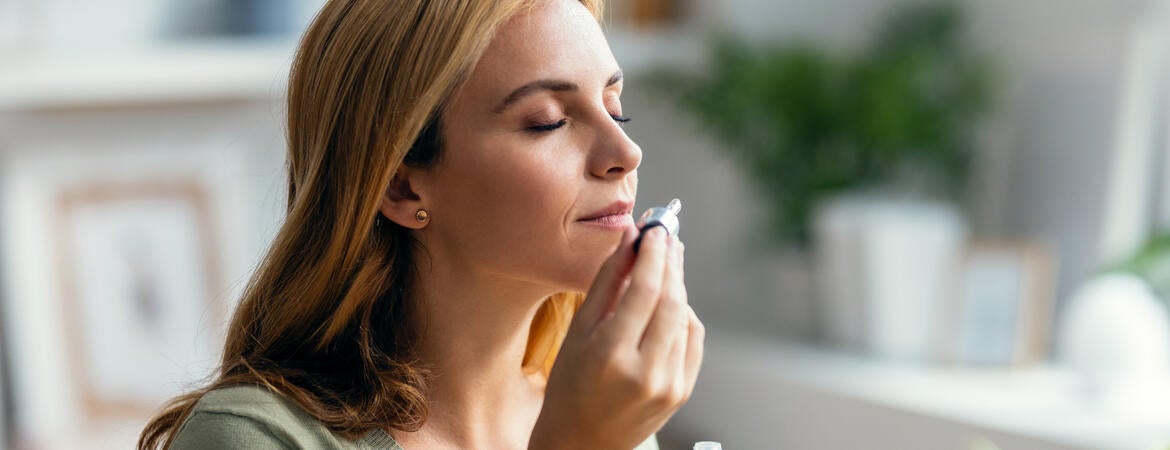 Woman smelling essential oil
