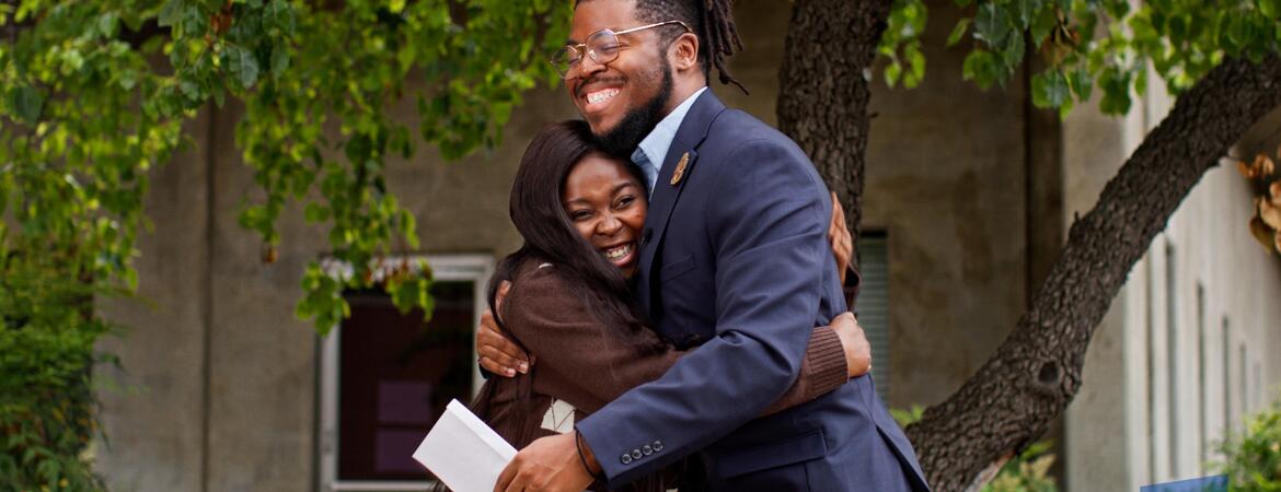 Student and staff mentor hugging
