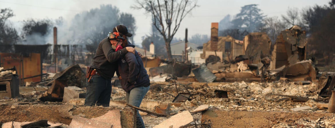 ALTADENA, CALIFORNIA - JANUARY 09: Khaled Fouad (L) and Mimi Laine (R) embrace as they inspect a family member's property that was destroyed by Eaton Fire on January 09, 2025 in Altadena, California. Fueled by intense Santa Ana Winds, the Eaton Fire has grown to over 10,000 acres and has destroyed many homes and businesses. (Photo by Justin Sullivan/Getty Images)