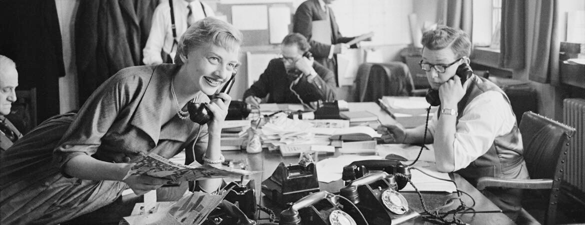 Young woman working with male colleagues in an English PR firm in 1954