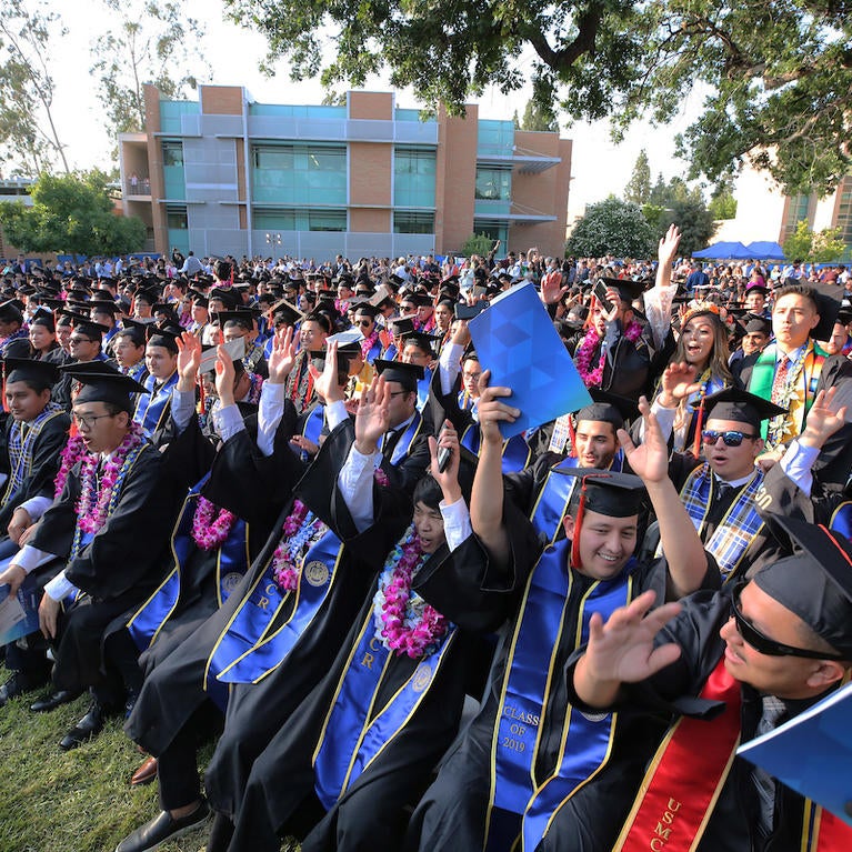 Graduates cheer at the UC Riverside commencement 