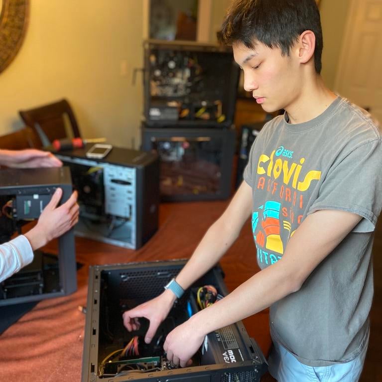 Freshman computer science student Ervin Young building a computer for low-income students