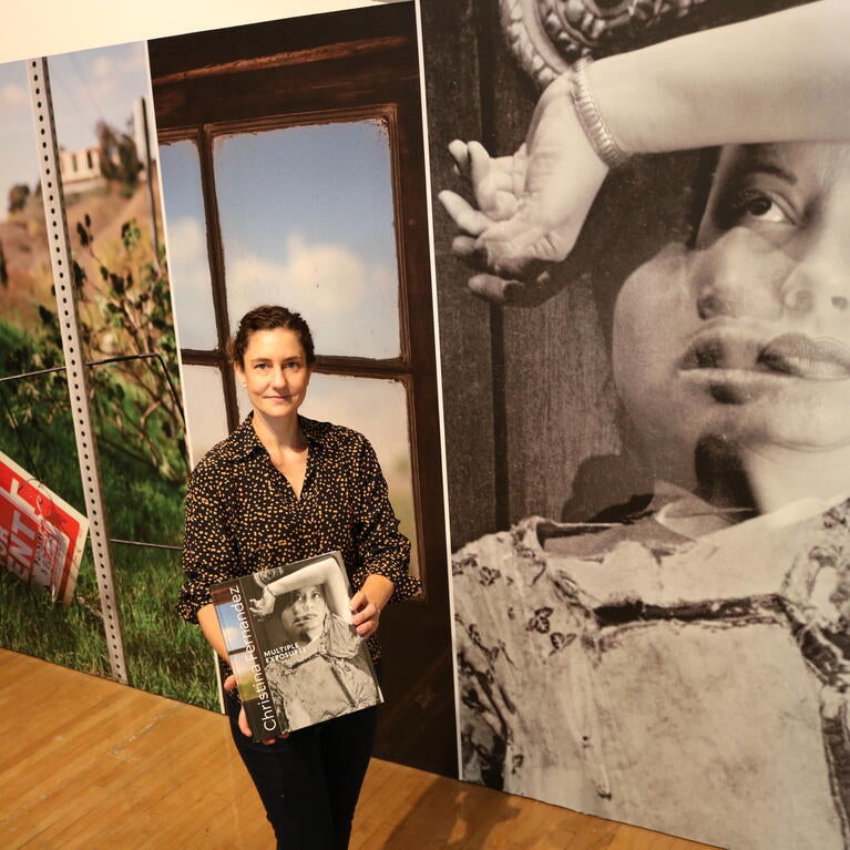 Joanna Szupinska, senior curator of exhibitions at UCR Arts, stands in front of the Christina Fernandez exhibition at the California Museum of Photography on Wednesday, September 7, 2022. (UCR/Sandra Baltazar Martínez)  