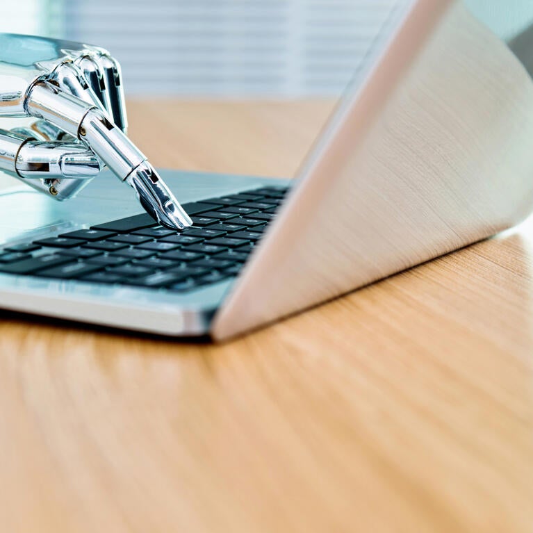 Robot hand on keyboard