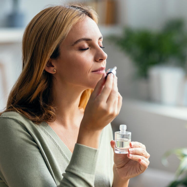 Woman smelling essential oil