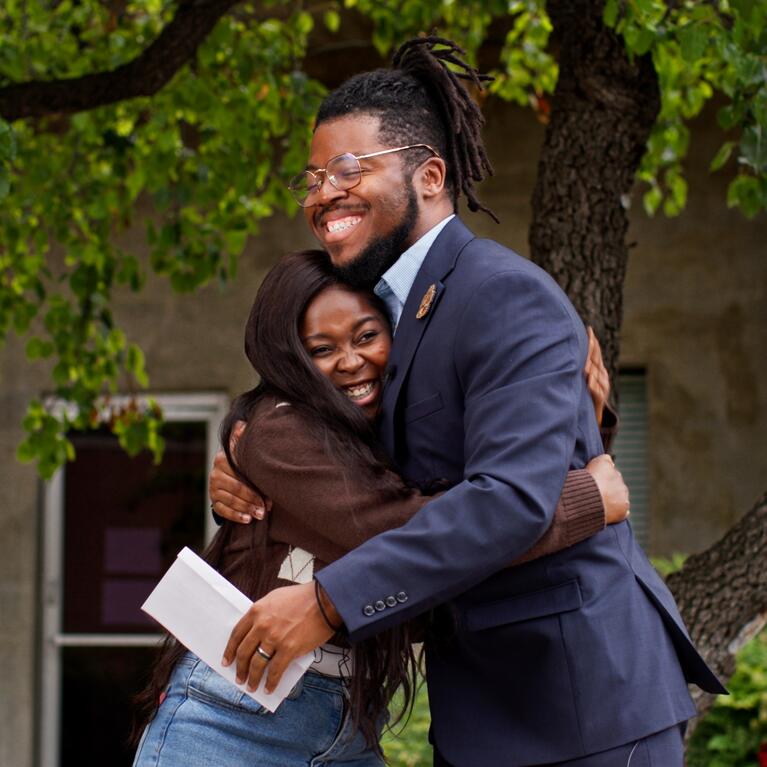 Student and staff mentor hugging