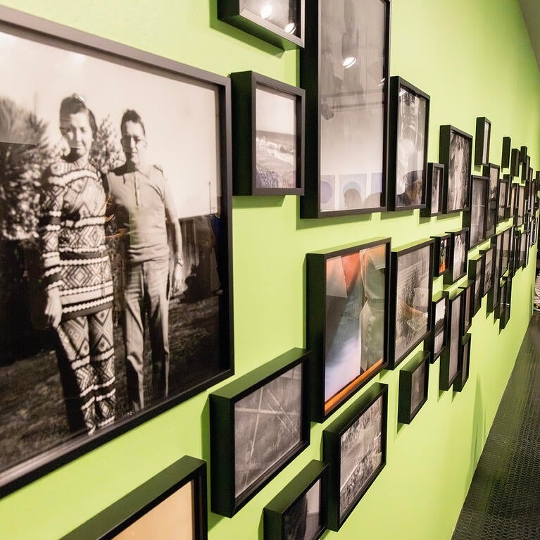 A woman views the "Shadow Archive" exhibition at UCR ARTS