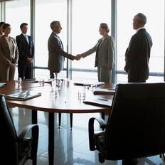 Corporate board room handshake