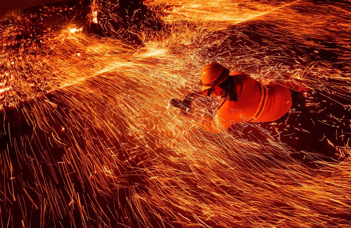Noah Berger, "Justin Sullivan shooting low, Camp Fire," 2018. (Courtesy of the artist and Associated Press)
