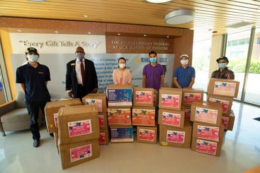 Representatives from the UCR School of Business receive a gift of surgical masks from the Chinese Americans Donation Center