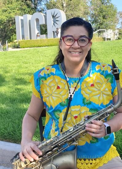 Xochitl Chavez holding saxophone