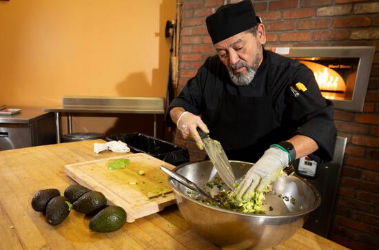 Senior cook Raul Hernandez Murillo making guacamole