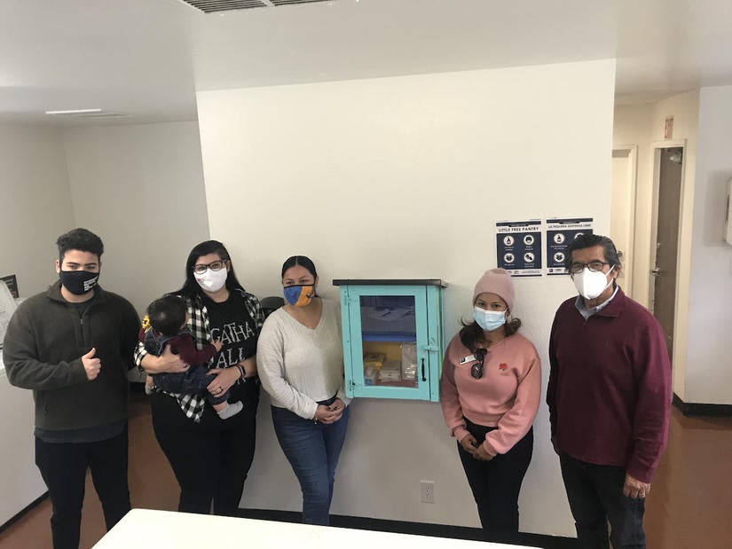 L-R: Aram Ayra ’18, with Riverside Mutual Aid Network; student parents Yvonne Marquez holding daughter Ramona, and Jazmin Garcia; Josaline Cuesta, City of Riverside Community and Economic Development project assistant; and Riverside Councilmember Andy Melendrez, on Friday, March 11, 2021. (UCR/Sandra Baltazar Martínez)