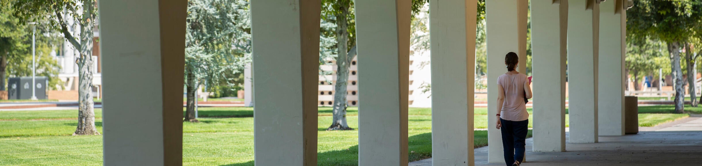 student walking under Rivera Arches (c) UCR/Stan Lim