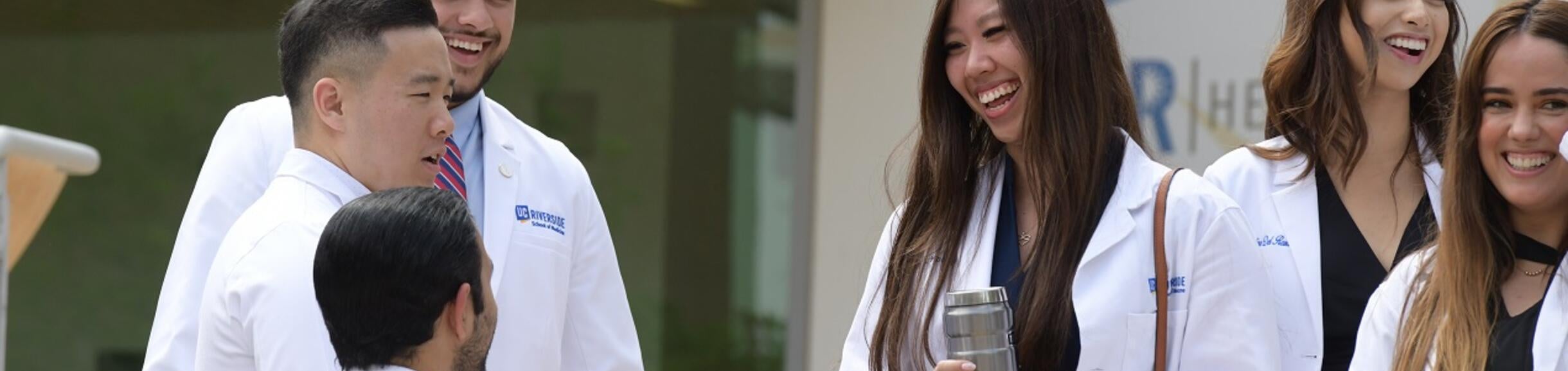 students on the steps of the building