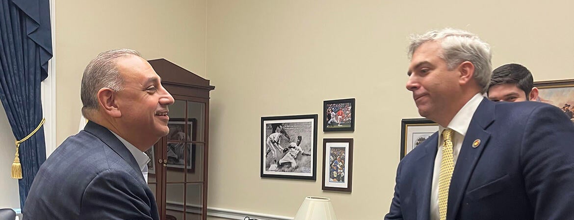 Scott Pegan shaking hands with Representative Gil Cisneros.