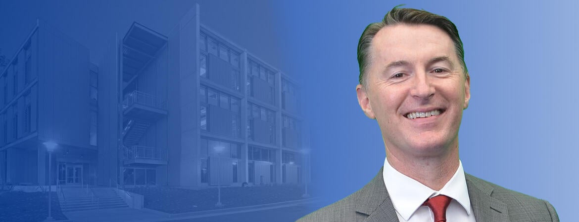 Declan McCole in front of a blue background