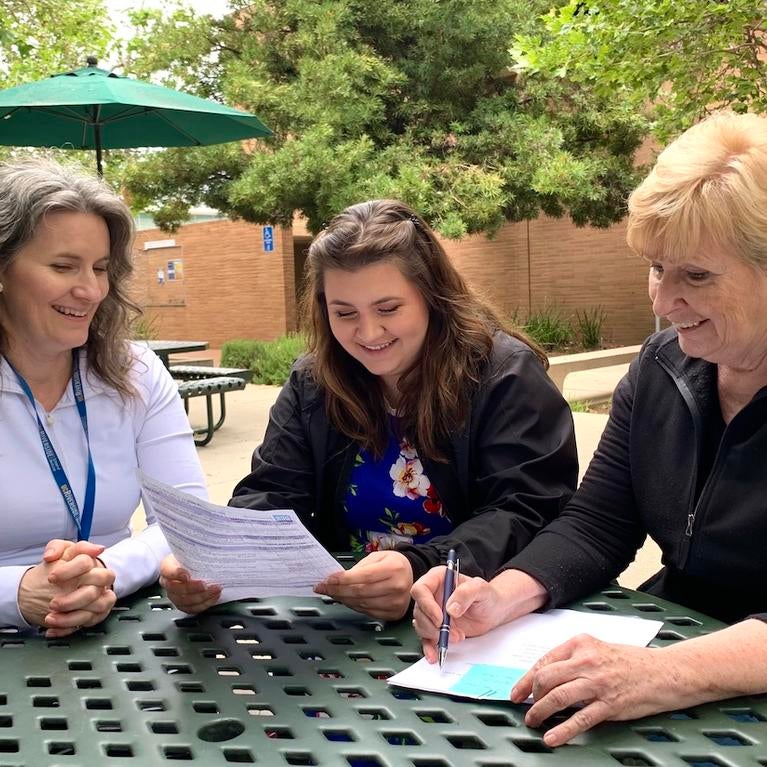 Escalona family reviewing Standardized Patient resources at a table