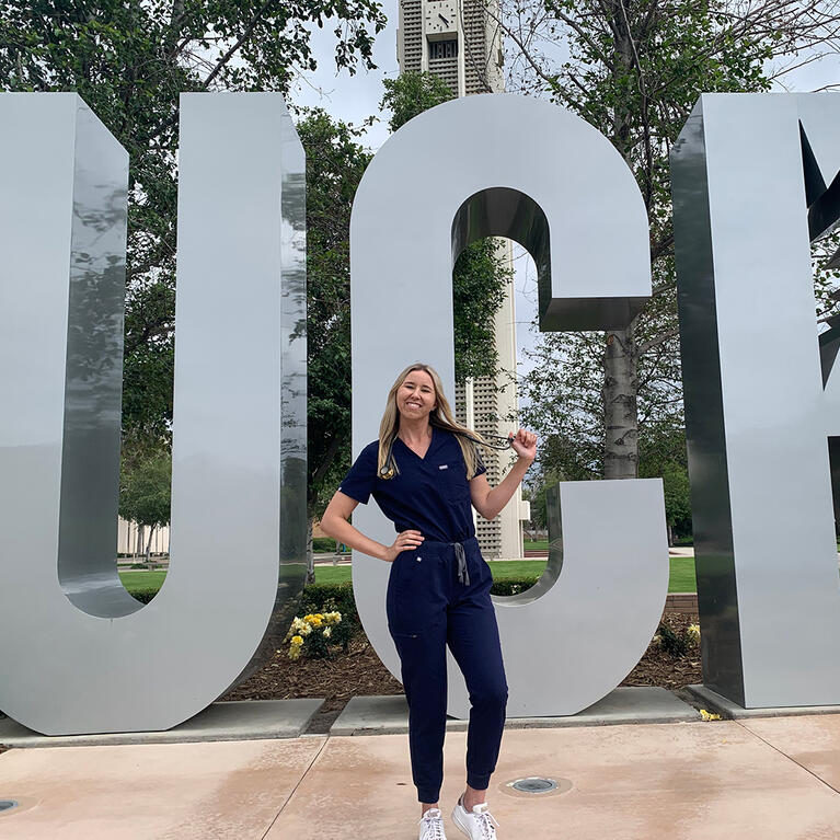 Skylar Rains in front of the UCR Sign