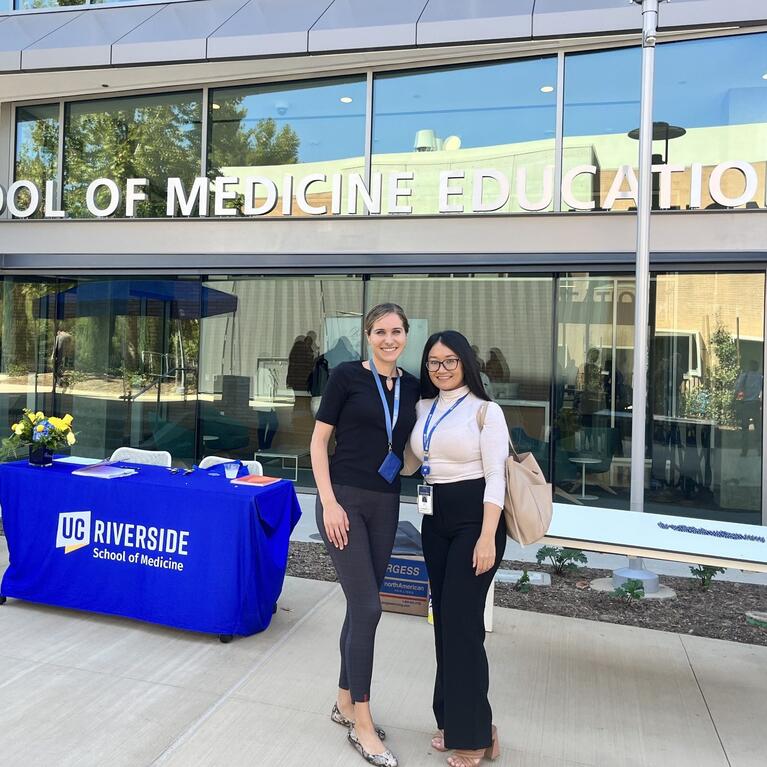 Arpy Barsemian and another administrative fellow in front of the SOM Ed II building