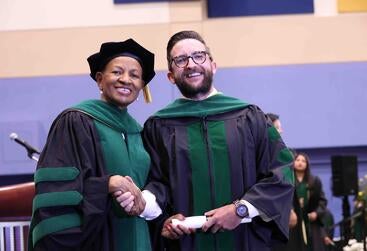 Dean Deas standing next to James Elkins at commencement 2025