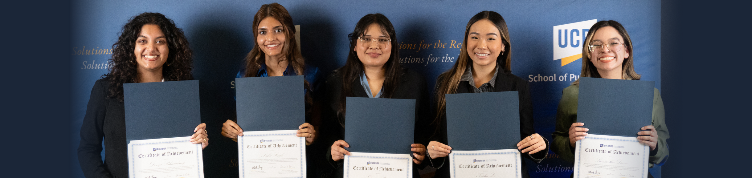 Five female students holding certifications for completing internships