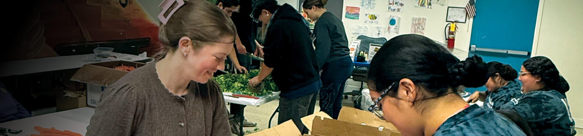 Volunteers cutting up vegetables for Highlanders Give Back 2025