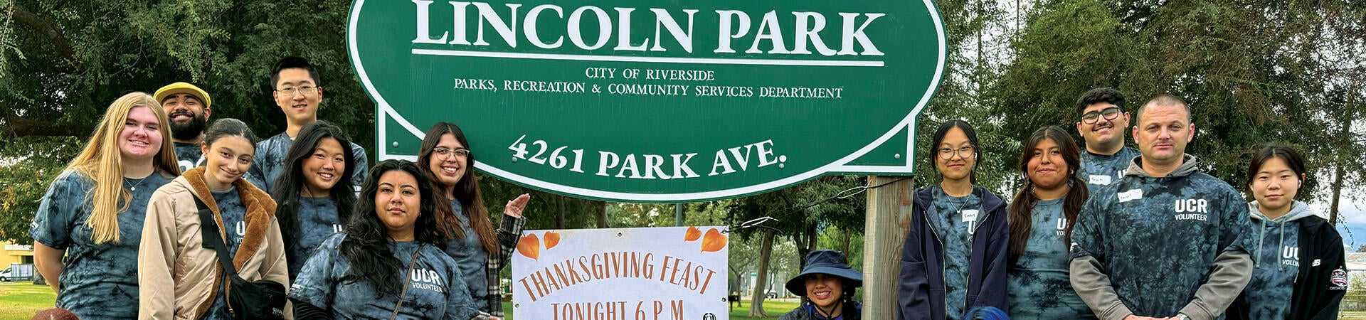 Volunteers in front of Lincoln Park Sign