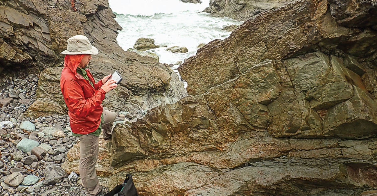 Barth reviewing data at a fault line in New Zealand.