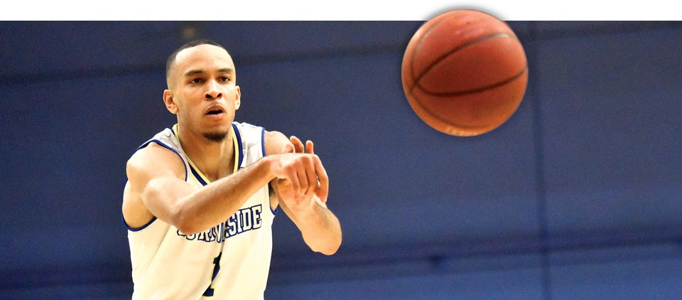 Hoops star Arinze Chidom passing a ball at a basketball game at the UCR Arena