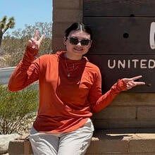 intern in front of Joshua Tree sign