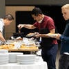Attendees getting breakfast from the self-serve buffet.