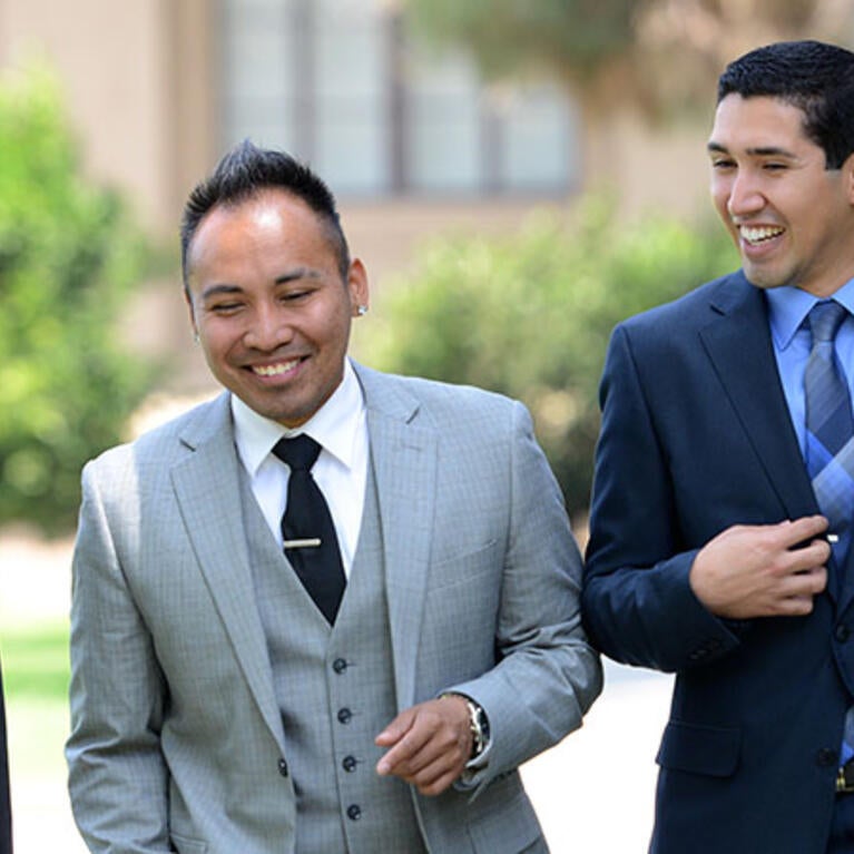 3 AGSM students walking around Anderson Hall