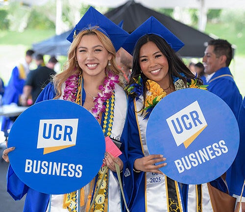 Two Graduates at the UCR School of Business Commencement Ceremony