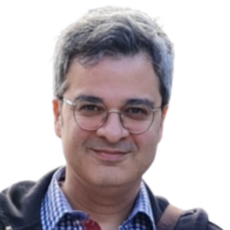 Dr. Amir Masoumi headshot, man with glasses and plaid shirt smiling