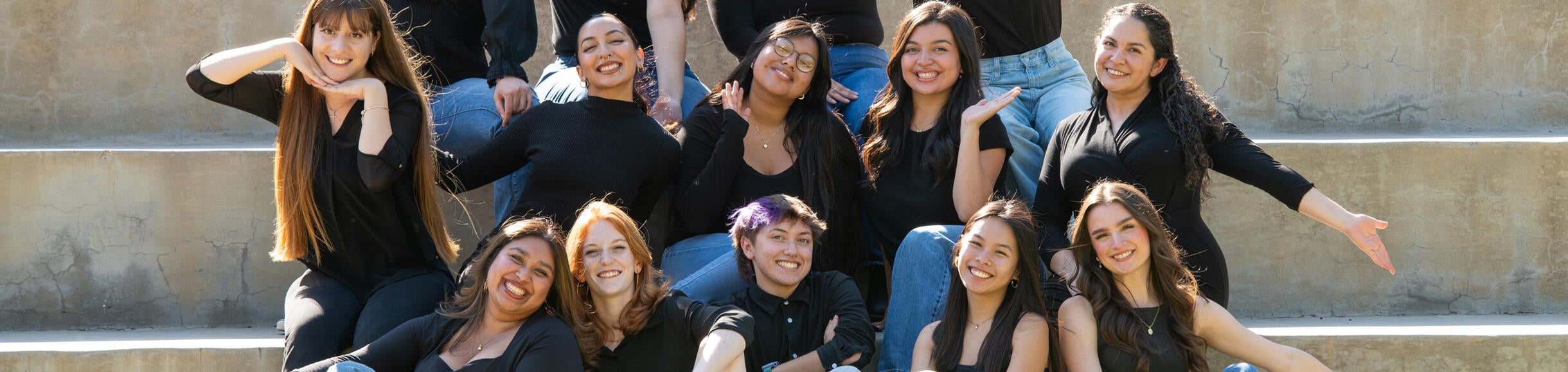 Group picture of WRC sitting on stairs.