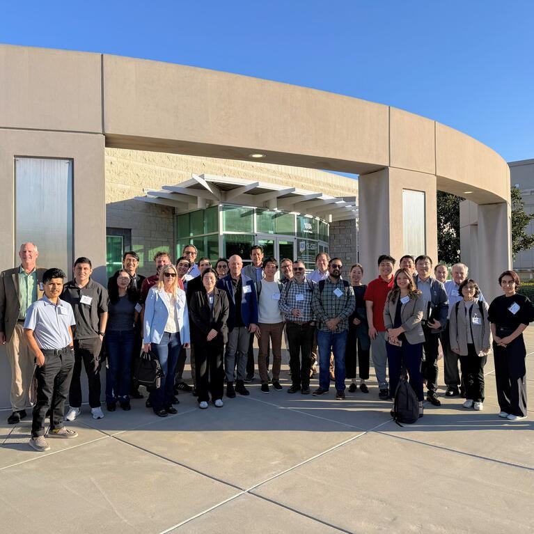 Group photo of more than 50 researchers, agency leaders, and policymakers standing outside the CE-CERT building during the OMEGA Dissemination Workshop, December 11, where CE-CERT presented findings on freight emissions monitoring, air quality impacts, and mitigation strategies in Inland Southern California.